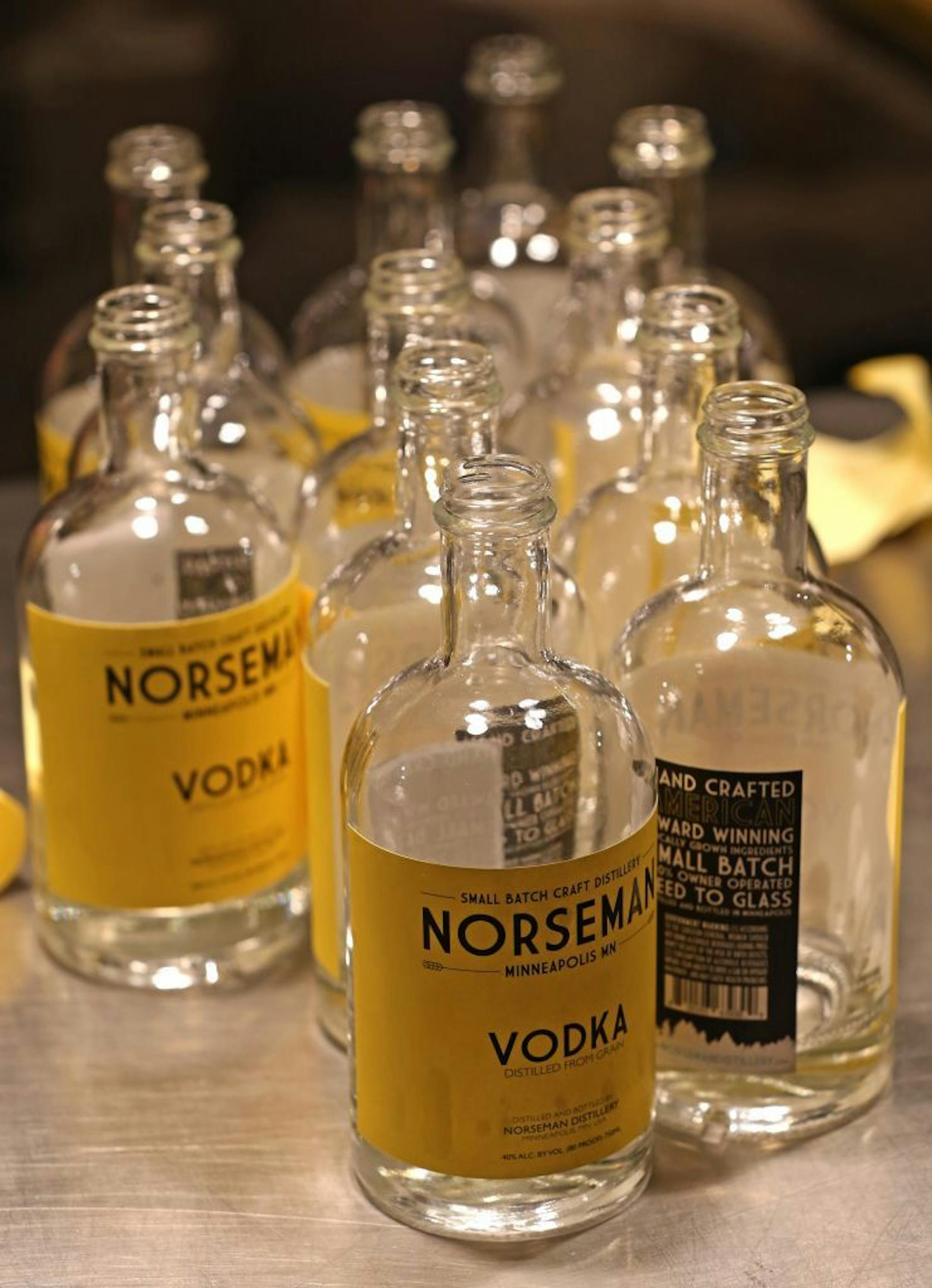 Scott Ervin applied final labels after filling bottles with Norseman Vodka in 2014. State officials have ordered the distillery to stop selling its Leathered Aquavit. "It's one of our most popular spirits," Ervin said.