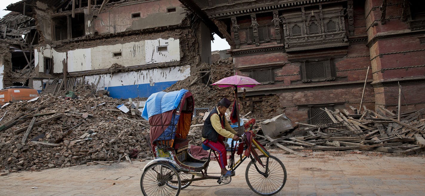 A Nepalese cycle rickshaw puller pedals past buildings at the Basantapur Durbar Square that were damaged in Saturday&#xed;s earthquake in Kathmandu, Nepal, Sunday, April 26, 2015. The earthquake centered outside Kathmandu, the capital, was the worst to hit the South Asian nation in over 80 years. It destroyed swaths of the oldest neighborhoods of Kathmandu, and was strong enough to be felt all across parts of India, Bangladesh, China's region of Tibet and Pakistan. (AP Photo/Bernat Armangue) ORG