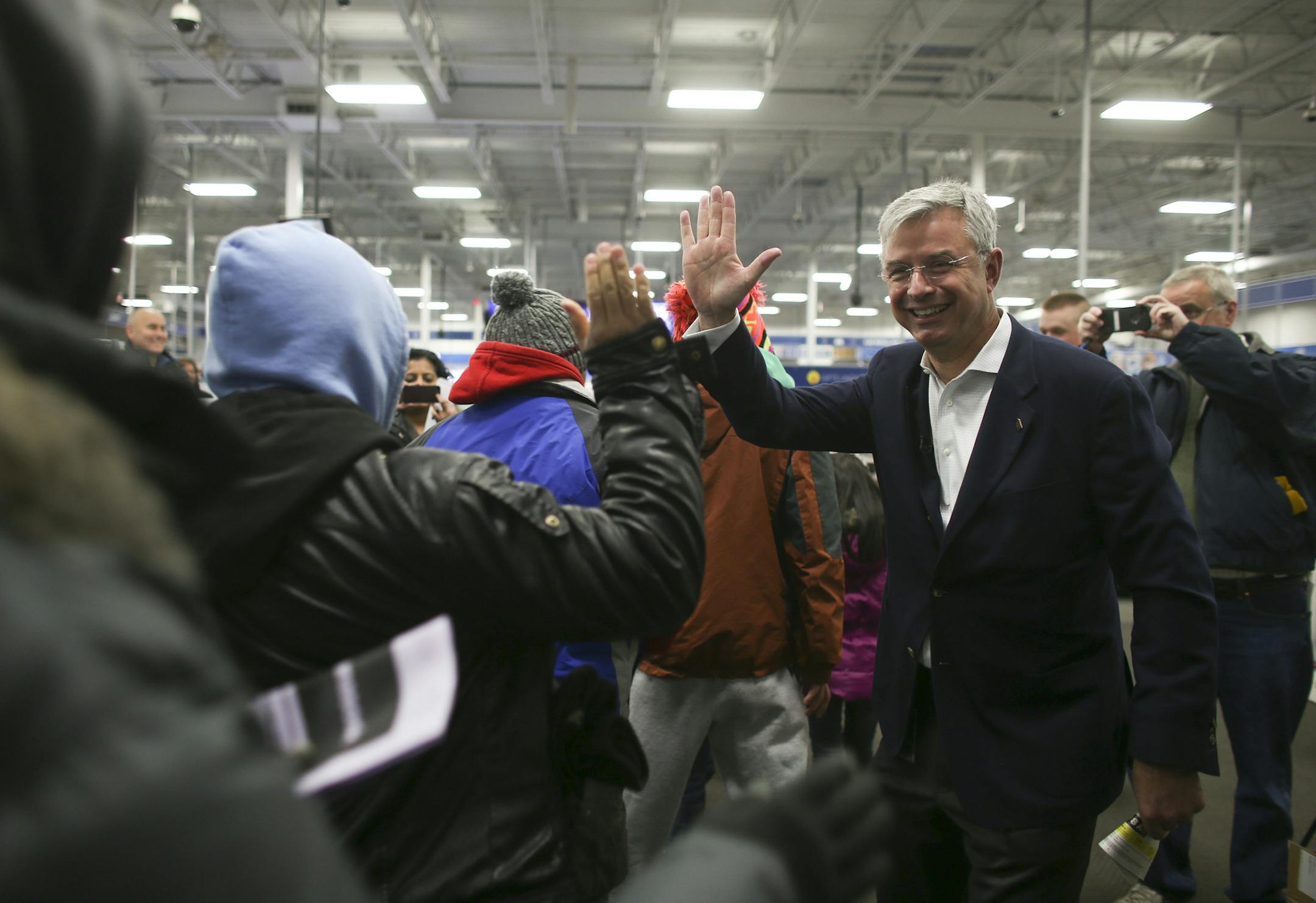 Best Buy CEO Hubert Joly high-fived and sometimes hugged customers as they entered a store in Roseville on Thursday.
