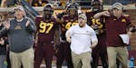 Minnesota's bench including head coach Tracy Claeys reacted as Minnesota's defensive back Antoine Winfield Jr. recovered the ball after a Purdue fumbl