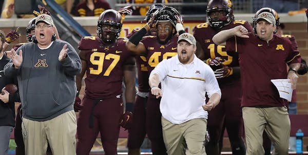 Minnesota's bench including head coach Tracy Claeys reacted as Minnesota's defensive back Antoine Winfield Jr. recovered the ball after a Purdue fumbl