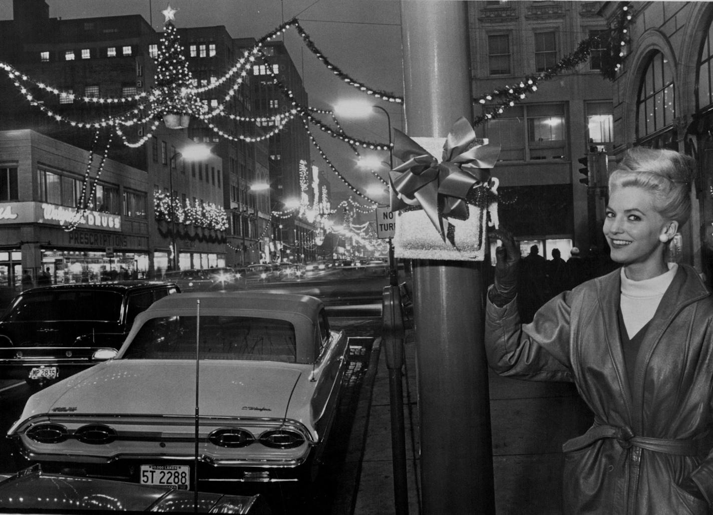 November 22, 1963 Christmas Downtown Penny Pilney, Miss Downtown, flicked a mockup switch at 9th St. and Nicollet Av. Thursday at 4:45 p.m. to turn on the lights and make it official that the Christmas season had arrived downtown. Later last night, at 7 p.m. the downtown area sparkled even more when lights were turned on in most of the downtown buildings. (Picture-Page 36.) November 21, 1963 Pete Hohn, Minneapolis Star Tribune