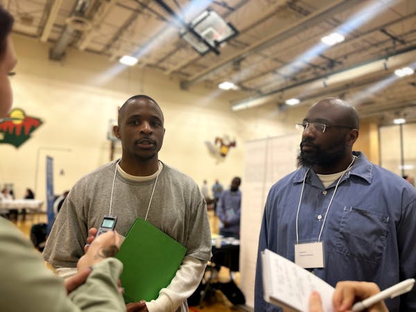 Deaunteze Bobo (left) and Jermaine Ferguson, both serving life sentences, volunteered at a resource fair at the Minnesota Correctional Facility in Rus