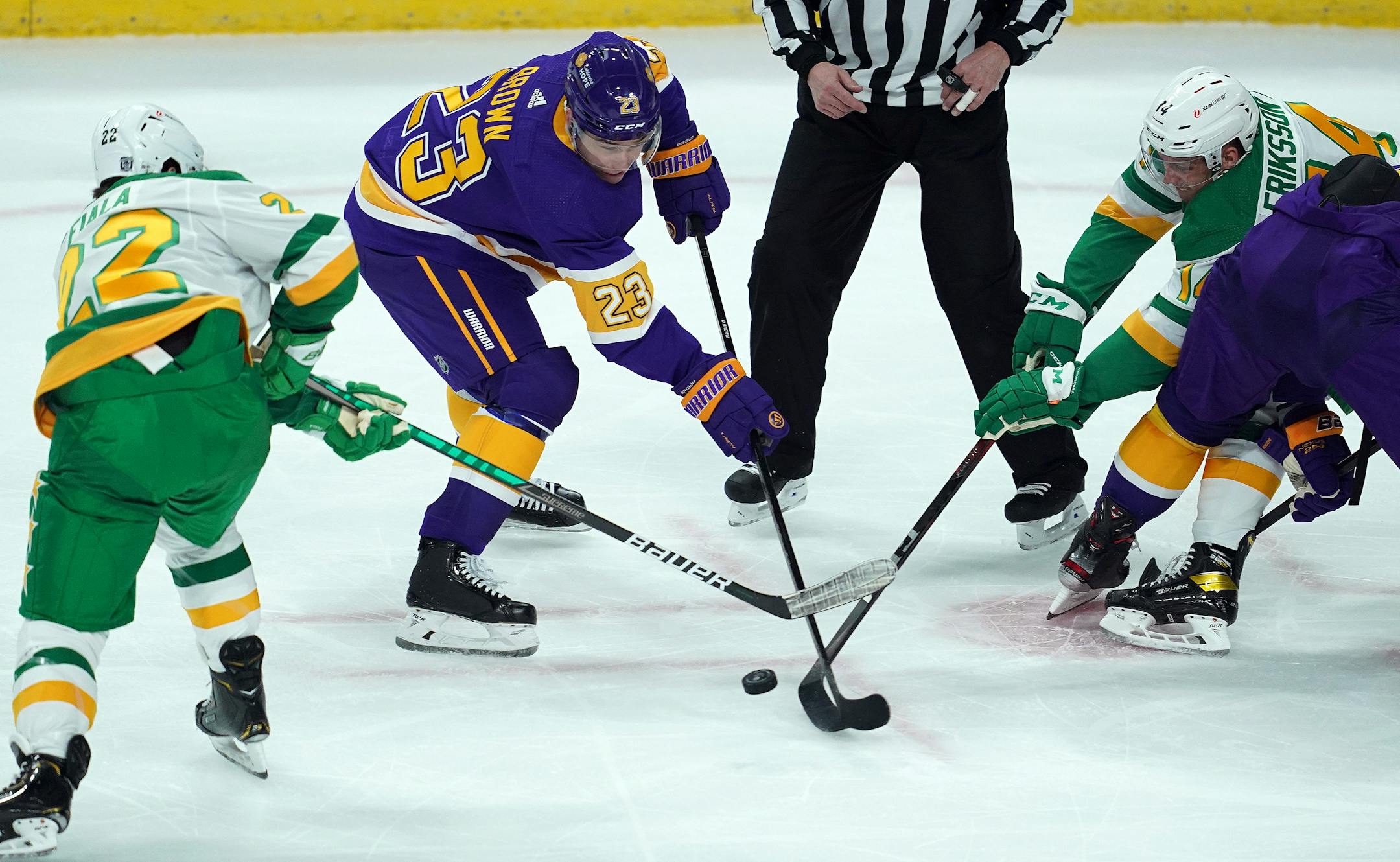 Los Angeles Kings right wing Dustin Brown and Minnesota Wild center Joel Eriksson Ek fought for the puck as Minnesota Wild left wing Kevin Fiala came in to assist in the first period.