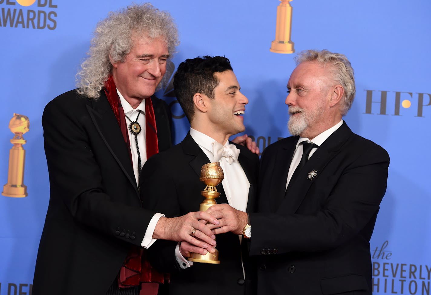 Rami Malek, a Golden Globe winner for playing Queen frontman Freddie Mercury in "Bohemian Rhapsody," celebrated with Mercury's bandmates Brian May and Roger Taylor.