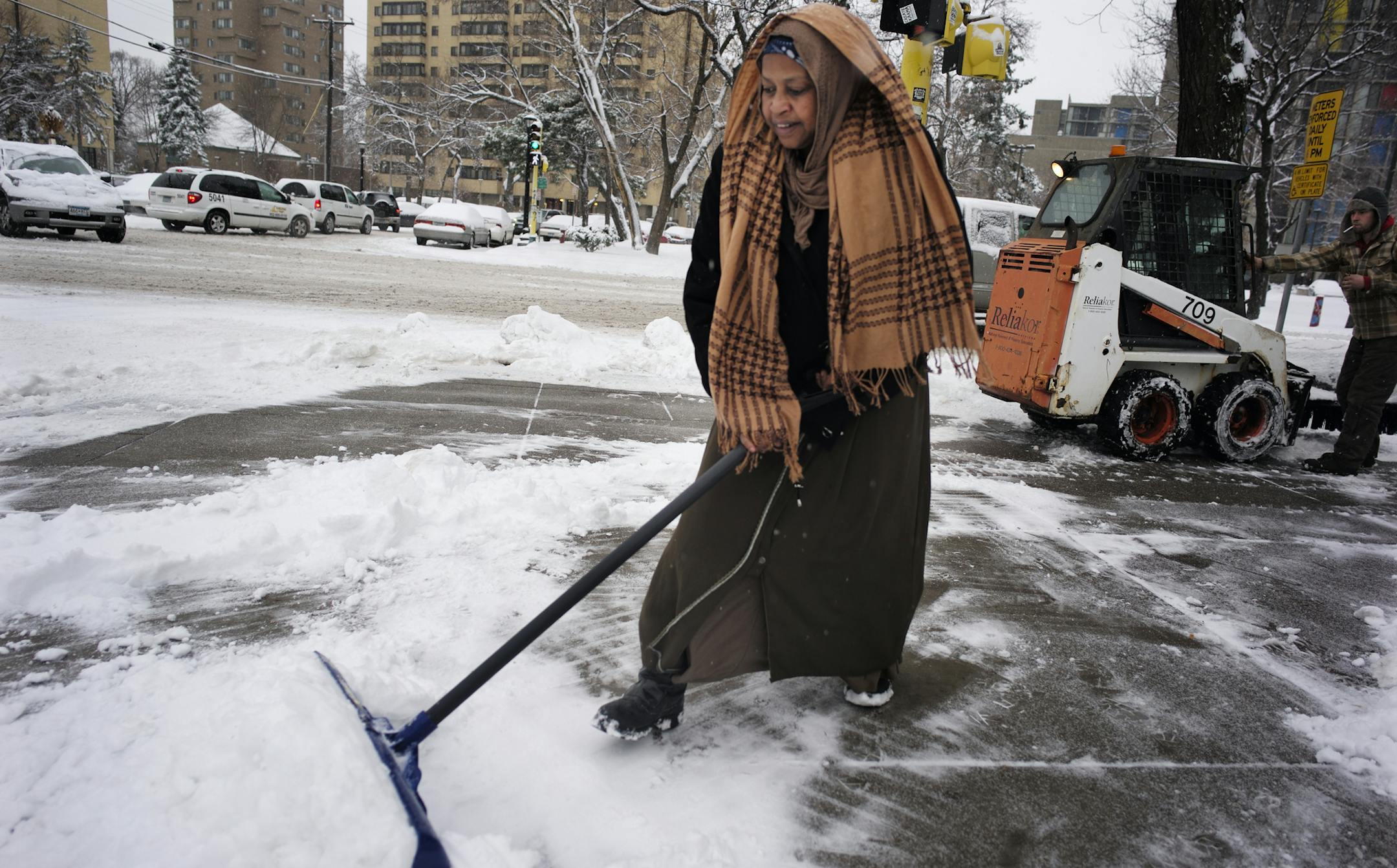 In the Cedar Riverside neighborhood, Kamaro Ali helped shovel the snow in front of a grocery store. Ali who is Oromo had only seen hail before coming before to Minnesota 15 years ago .]richard tsong-taatarii/rtsong-taatarii@startribune.com