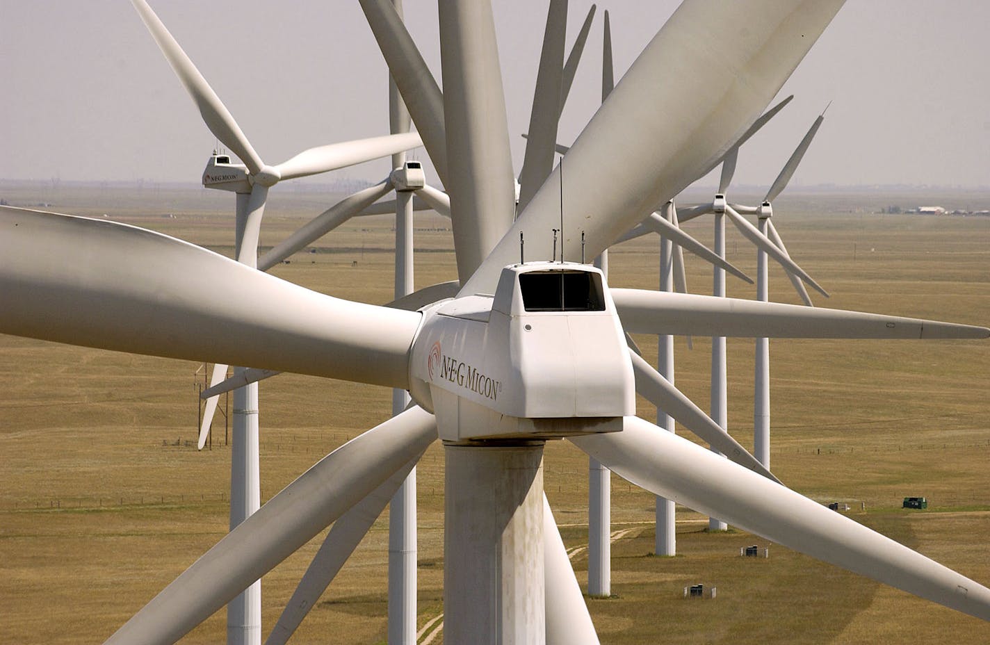 Wind turbine generators rotate in the Colorado sunshine Monday, August 16, 2004, at the Ponnequin wind farm in northern Colorado. Xcel Energy plans to triple its wind capacity in the state in the next three years. Each turbine tower can generate up to 750 kilowatts. Photographer: Neal Ulevich/ Bloomberg News.