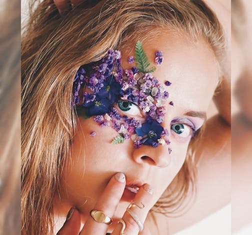 photo of author Mary E. Roach, with glitter and flowers on her face