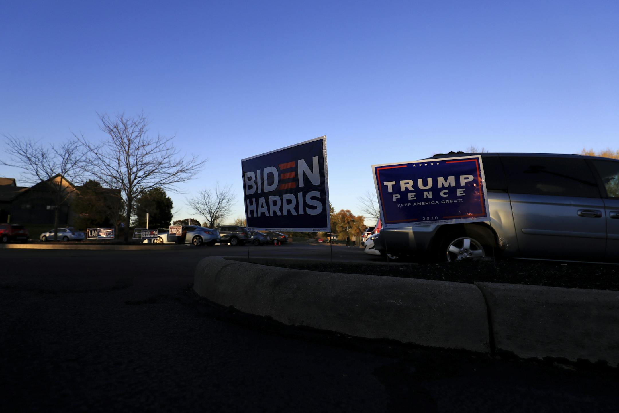 A view of campaign signs in support of Democratic presidential candidate, former Vice President Joe Biden, and President Donald Trump, at the Fairfield Greens South Trace Golf Course polling location on Election Day, Nov. 3, in Cincinnati.