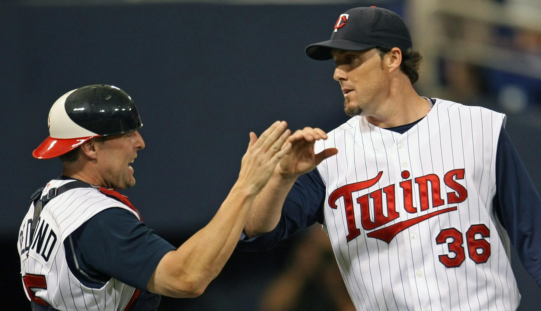Minnesota Twins vs. Oakland Athletics. (left to right) Twins Mike Redmond and Joe Nathan celebrated their win over Oakland at the end of the game.