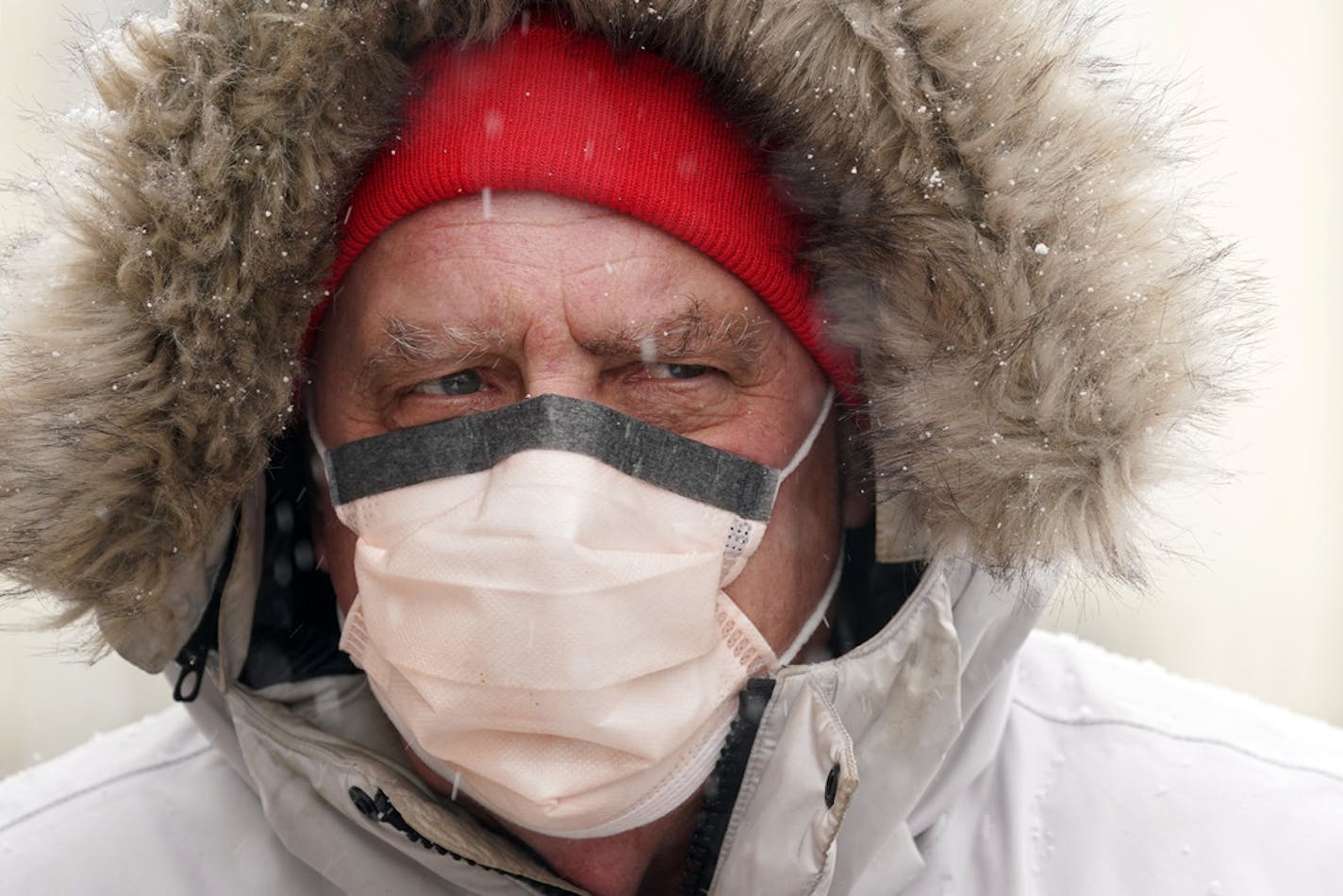 Larry Utterback of Minneapolis wore a winter coat to protect himself from the cold and a surgical mask to protect himself from coronavirus in Minneapolis on April 14.