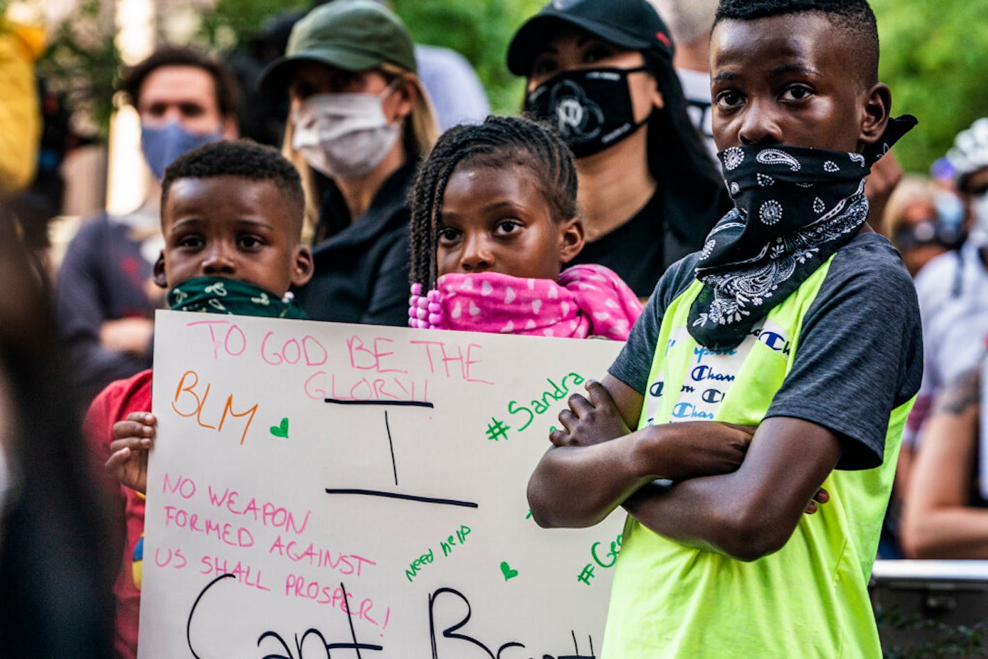 Malakai 9, his brother Levi, 7, and his sister Naliah, 8, attended a rally Thursday with several hundred people outside the Hennepin County Government Center in downtown Minneapolis with their mother, Shawna Perkins (not pictured). "We are fighting for change so we don't have to do this when we get older," she said.