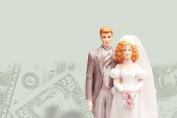 200 dpi 63p x 77p Rick Nease color illustration of a bride and groom wedding cake figurine set on a stack of coins against a background of money. Detr