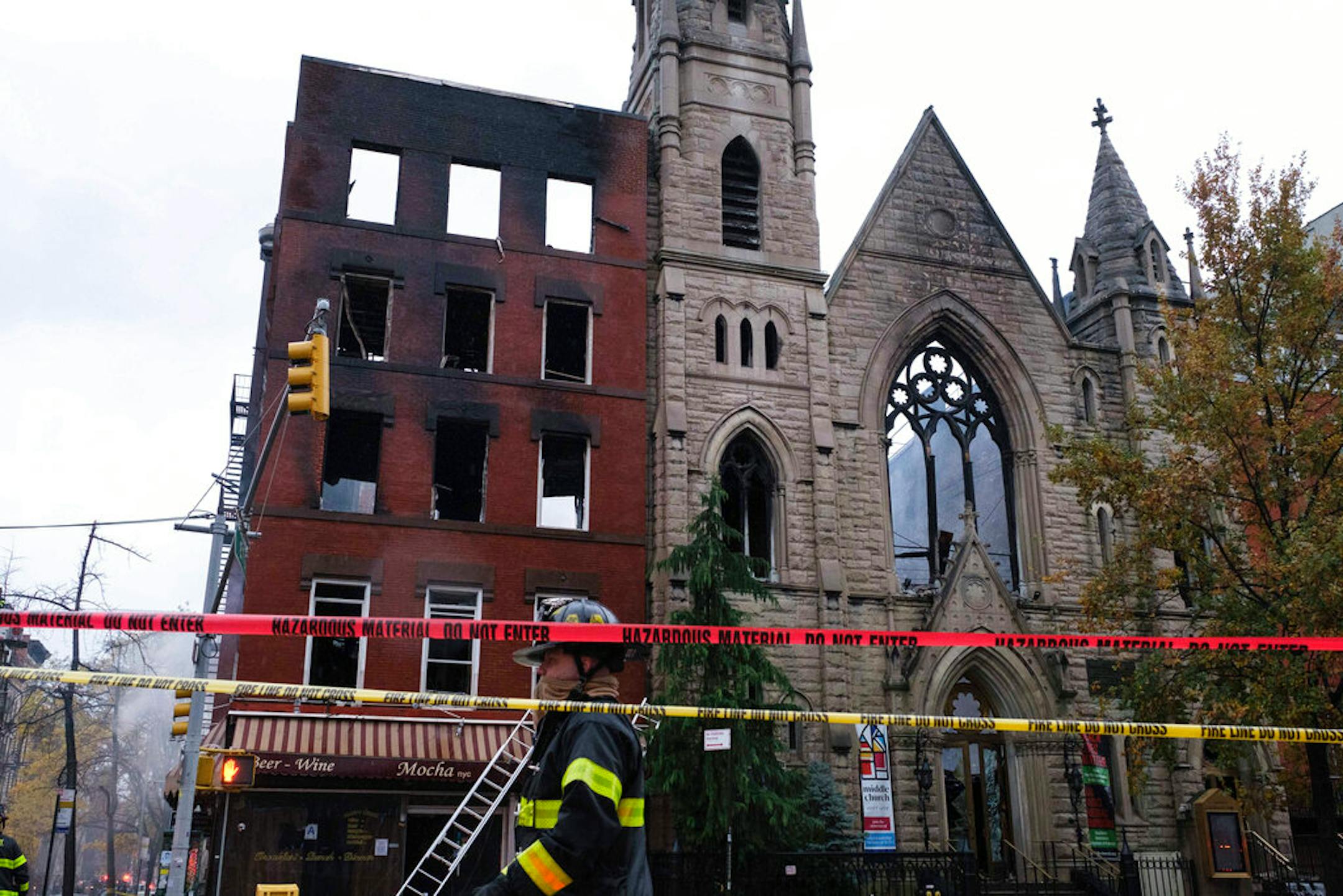 Firefighters worked to extinguish a fire erupted from the building next to Middle Collegiate Church on Saturday, Dec. 5, 2020 in New York. The historic 19th-century church in lower Manhattan was gutted by a massive fire early Saturday that sent flames shooting through the roof.