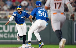 Two players who will determine much about the Twins' success this season, Carlos Correa and Willi Castro (50), complete a play Friday against San Fran
