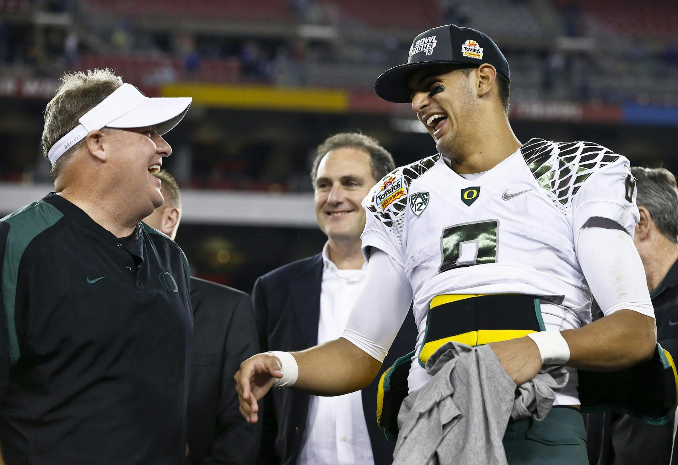 Oregon head coach Chip Kelly, left, laughs with Marcus Mariota after the Fiesta Bowl NCAA college football game against Kansas State Thursday, Jan. 3, 2013, in Glendale, Ariz. Oregon defeated Kansas State 35-17.(AP Photo/Ross D. Franklin) ORG XMIT: PNP168