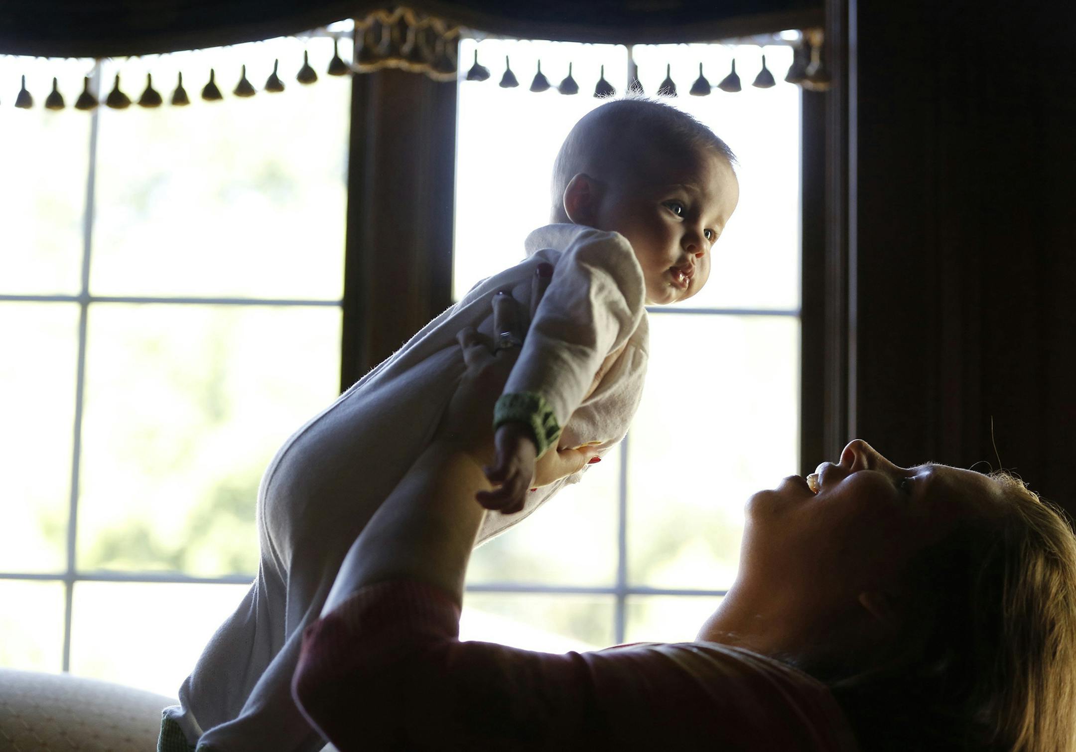 Molly Halper, right, and her 5 month-old baby, Georgette Halper, are photographed in their Arlington Heights, Illinois home, August 1, 2013. After the birth of Georgette, Molly Halper ingested encapsulated placenta pills made for her by her birth doula. (Stacey Wescott/Chicago Tribune/MCT) ORG XMIT: 1142238