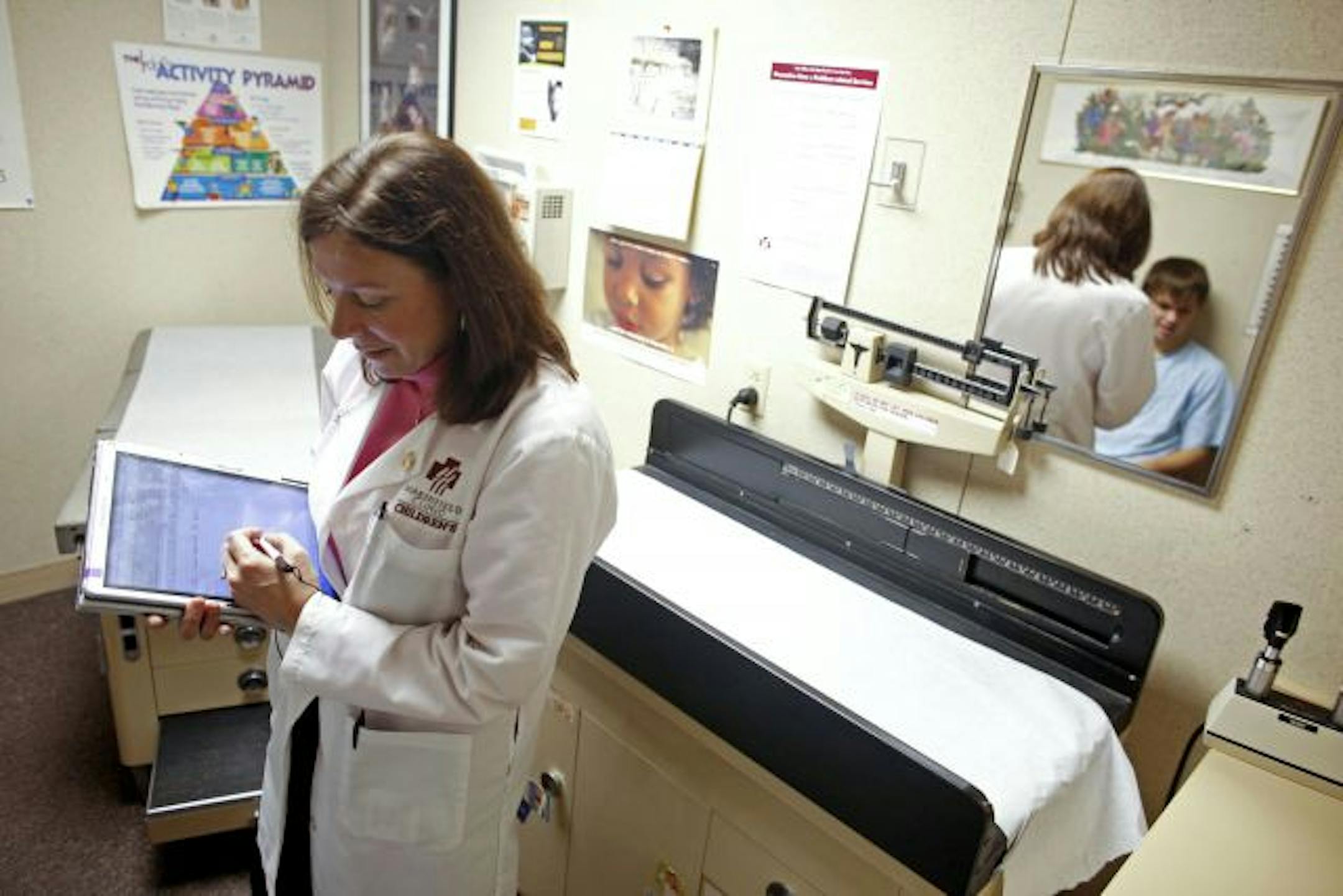 FILE -- Dr. Edna Devries enters information on a tablet computer at the Marshfield Clinic, which was an early adopter of electronic records, in Marshfield, Wis., on Dec. 19, 2008. A change to electronic data has the potential for broad health and economic benefits, but also presents huge design and social challenges. (Darren Hauck/The New York Times) -- PHOTO MOVED IN ADVANCE AND NOT FOR USE - ONLINE OR IN PRINT - BEFORE FEB. 27, 2011.