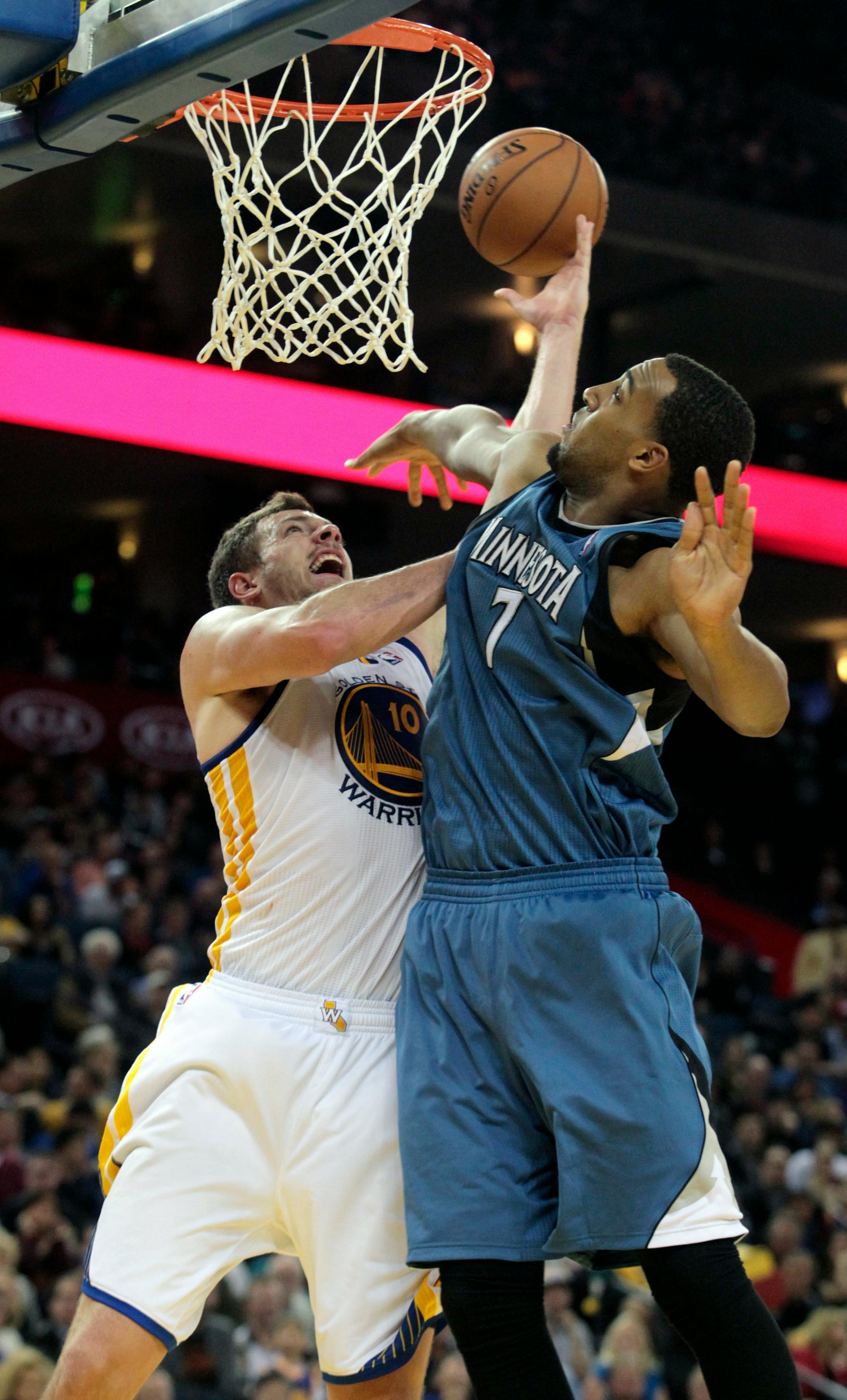 Golden State Warriors' David Lee (10) drives to the basket against the Minnesota Timberwolves' Derrick Williams (7) in the second half of an NBA basketball game in Oakland, Calif., Saturday, Nov. 24, 2012. The Warriors won 96-85. (AP Photo/Mathew Sumner)