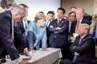 German Chancellor Angela Merkel speaks to President Donald Trump during the second day of the G-7 summit meeting in La Malbaie, Quebec, Canada, June 9