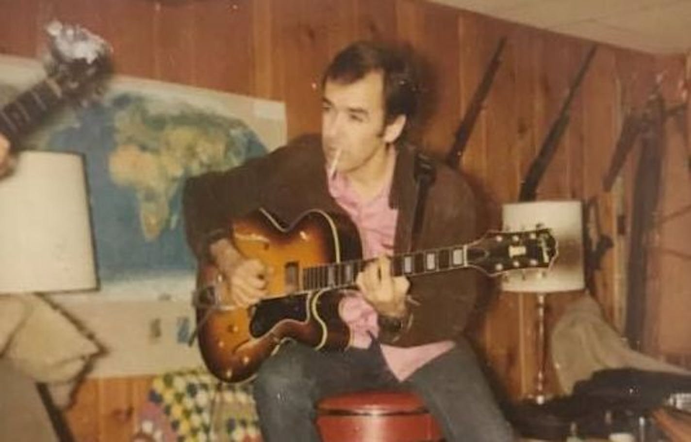 Richard A. Caire plays guitar sometime in 1971. Caire, a pioneering rock & roll musician, died June 2 at 81.