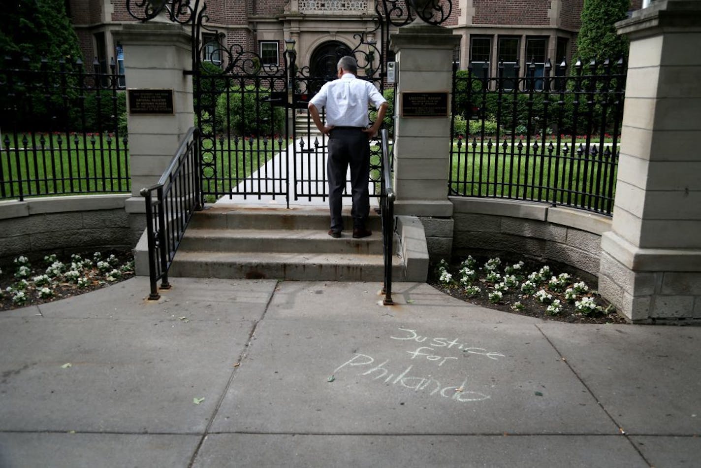 A message calling for justice for Philando Castile is written in chalk Saturday on the sidewalk outside the Governor's Mansion in St. Paul.