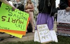 Protestors with signs gather outside the Walker Sculpture Garden Saturday, May 27, 2017, in Minneapolis. The Walker Art Center in Minneapolis said Sat