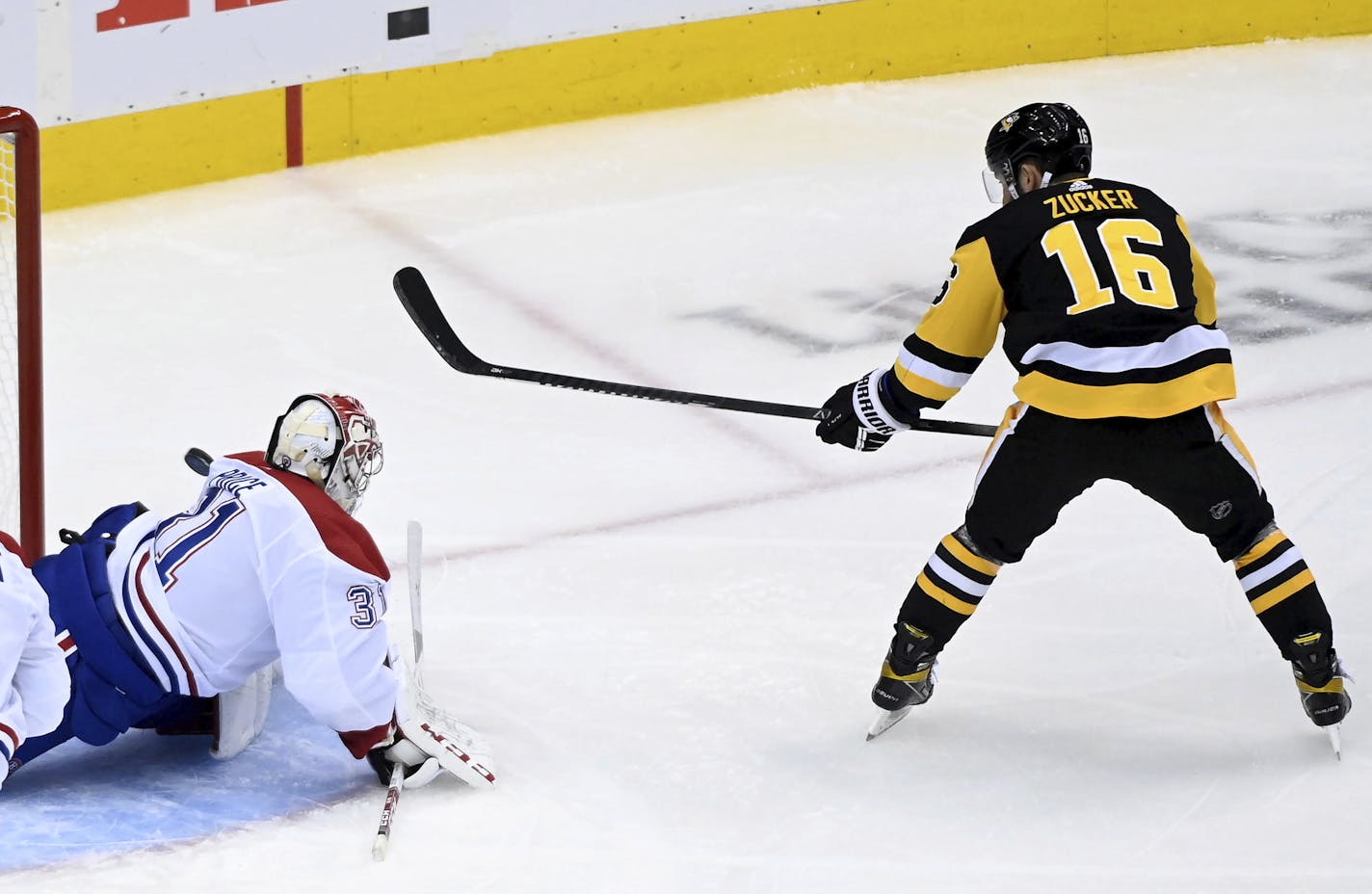 Pittsburgh Penguins left wing Jason Zucker (16) gets stopped by Montreal Canadiens goaltender Carey Price (31) during the first period of an NHL hockey playoff game Saturday, Aug. 1, 2020 in Toronto. (Nathan Denette/The Canadian Press via AP)