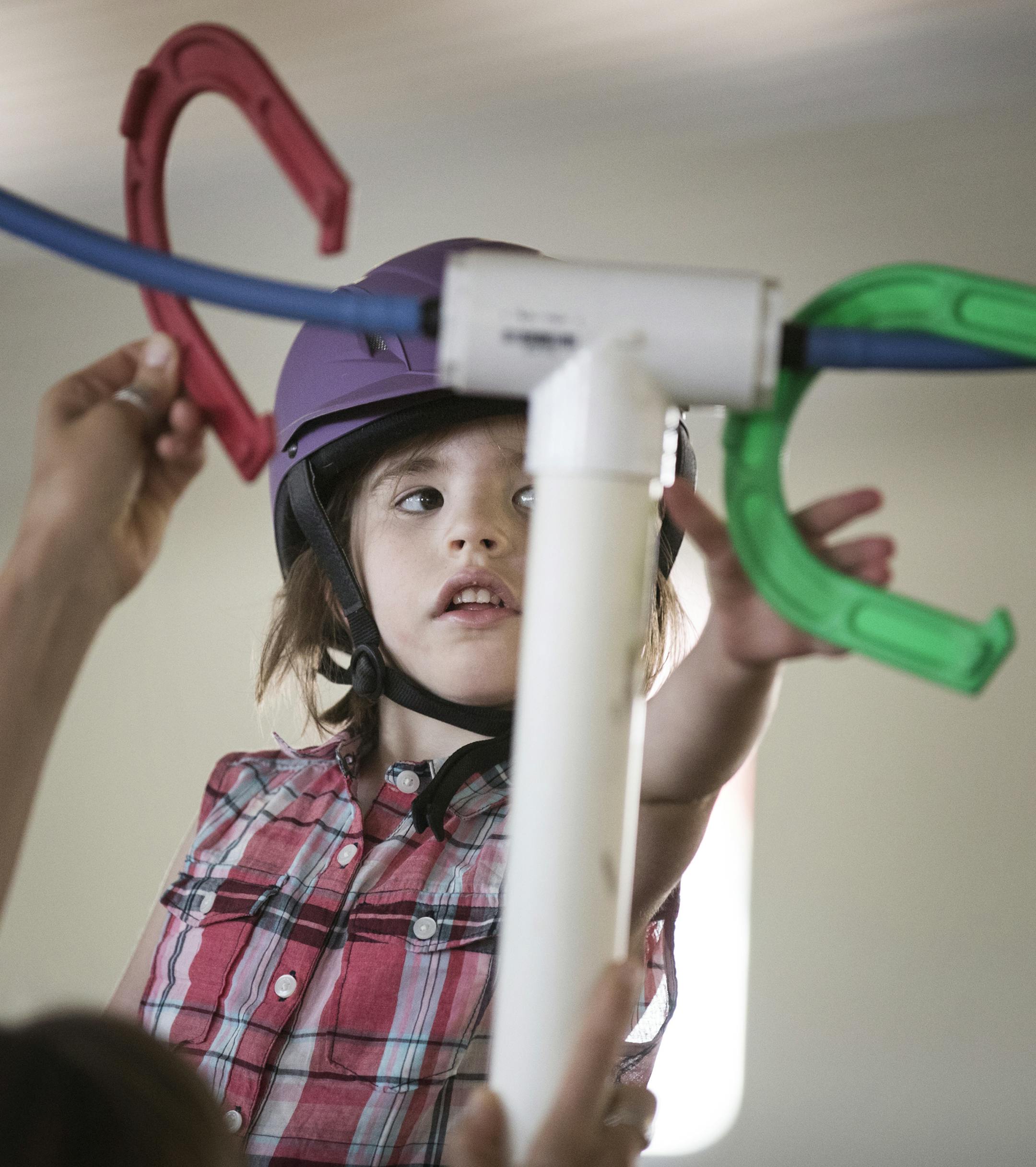 Ellie Soderberg, 4, participates in an occupational therapy session at Hold Your Horses in Maple Plain. ] (Leila Navidi/Star Tribune) leila.navidi@startribune.com BACKGROUND INFORMATION: Wednesday, July 13, 2016 in Maple Plain. Hold Your Horses, a horse therapy program in Maple Plain, is moving barns in August. After thinking they would lose the whole program, a landowner offered a half sale/donation that will allow the program to continue and expand.