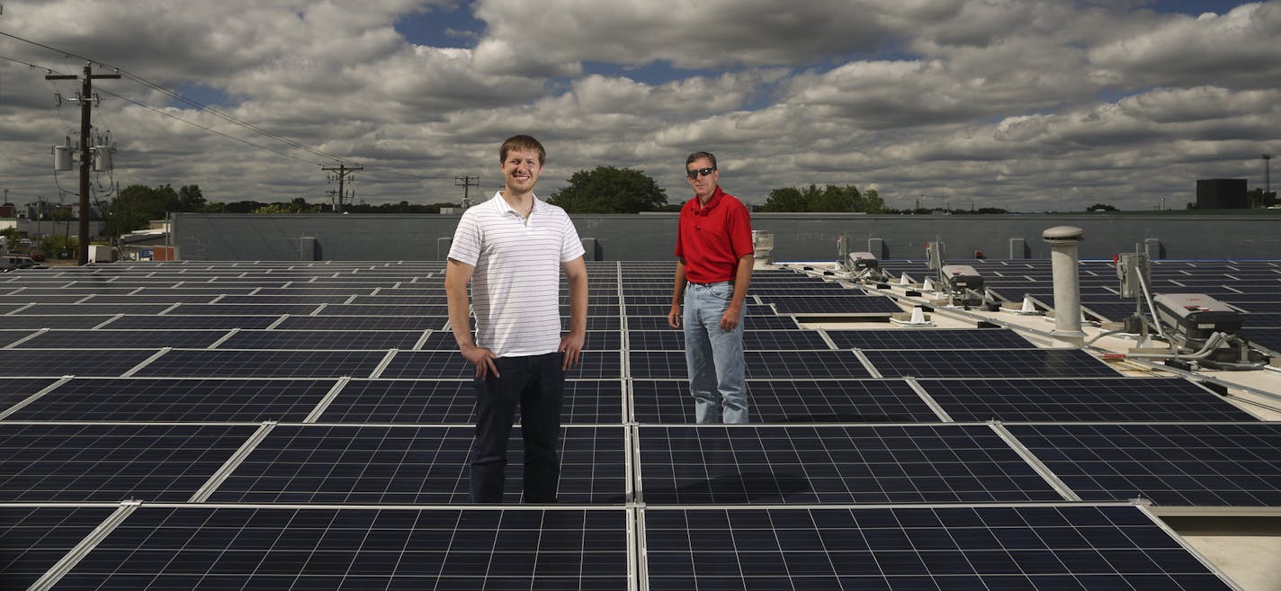 A solar garden atop a St. Paul warehouse is one of three that Novel Energy Solutions has up and running. Pictured are Novel&#x2019;s Cliff Kaehler, left, and Duane Hebert.