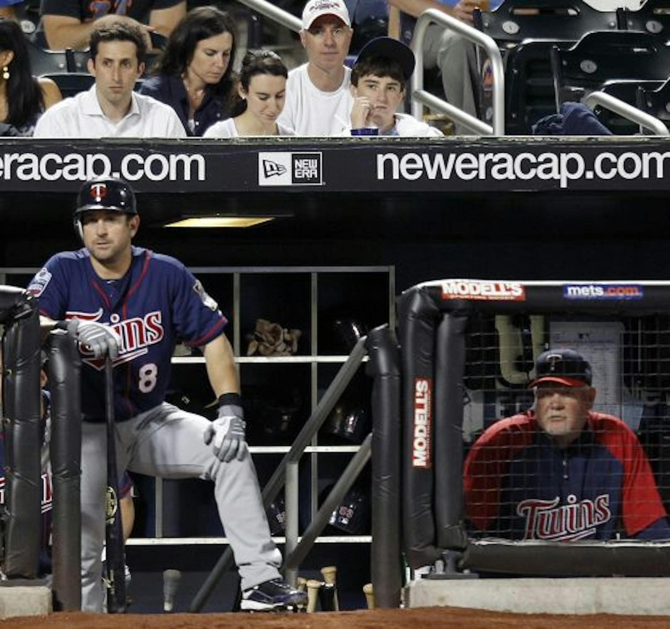 Minnesota Twins' Nick Punto (8) and manager Ron Gardenhire, right, watch during the seventh inning of a baseball game against the New York Mets at Citi Field in New York, Friday, June 25, 2010. The Mets won 5-2.