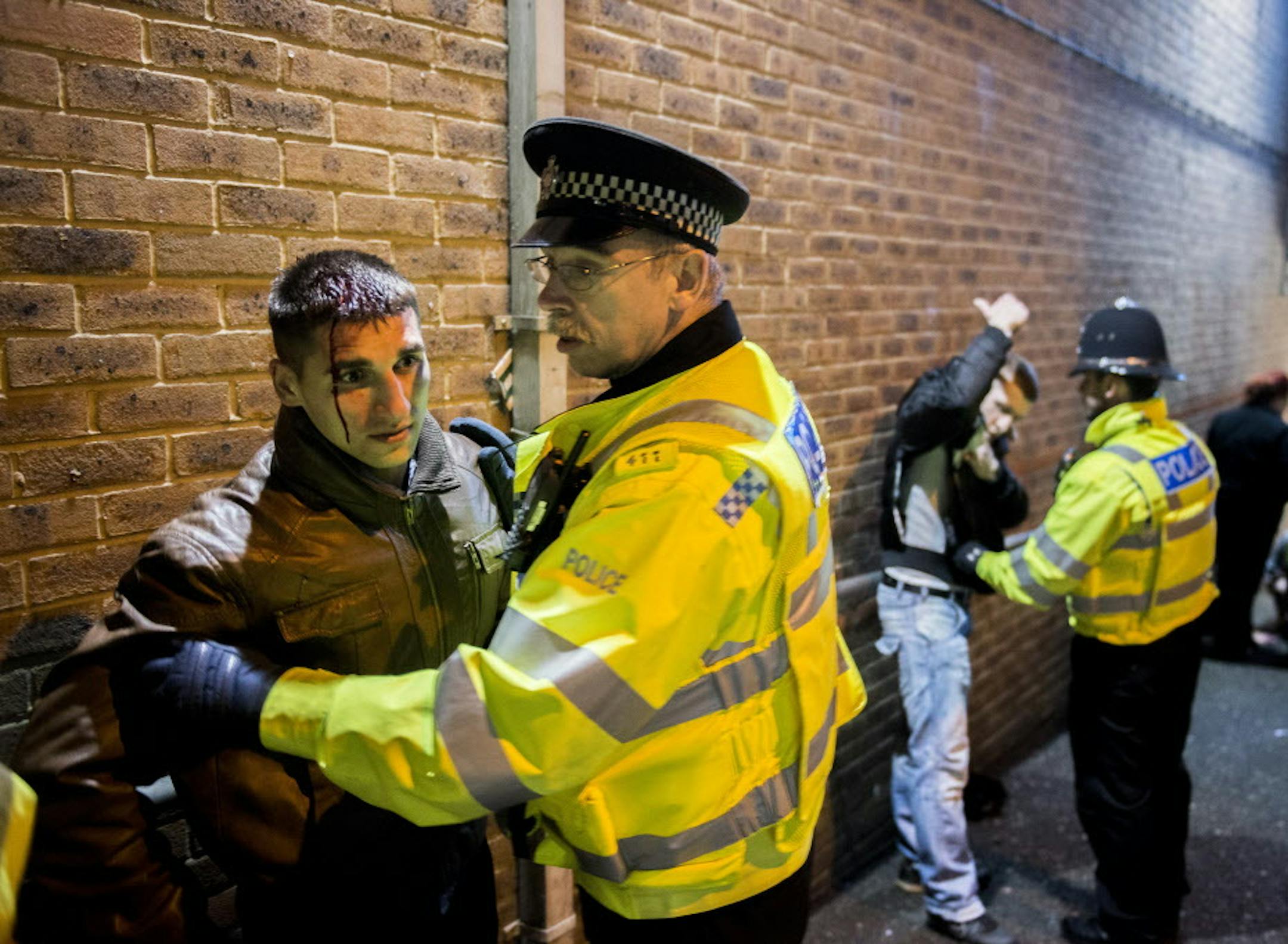 Police officers break up a drunken fight in Northampton, England, Dec. 7, 2013. Officials in Northampton are tackling binge drinking as the issue grows in social importance, because of both the violence that alcohol often engenders and the vulnerability of young women who are in no condition to defend themselves. (Andrew Testa/The New York Times)