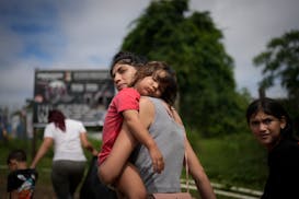 Venezuela migrant Naiber Zerpa holds her son Mathias Marquez last month as they arrive at a temporary camp in Panama after walking across the Darién 
