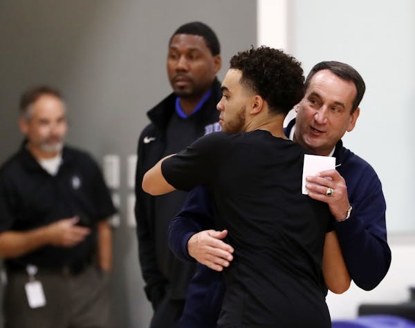 Duke and Team USA head coach Mike Krzyzewski gave a hug to former Duke and Apple Valley star Tyus Jones at Tuesday's Wolves practice.