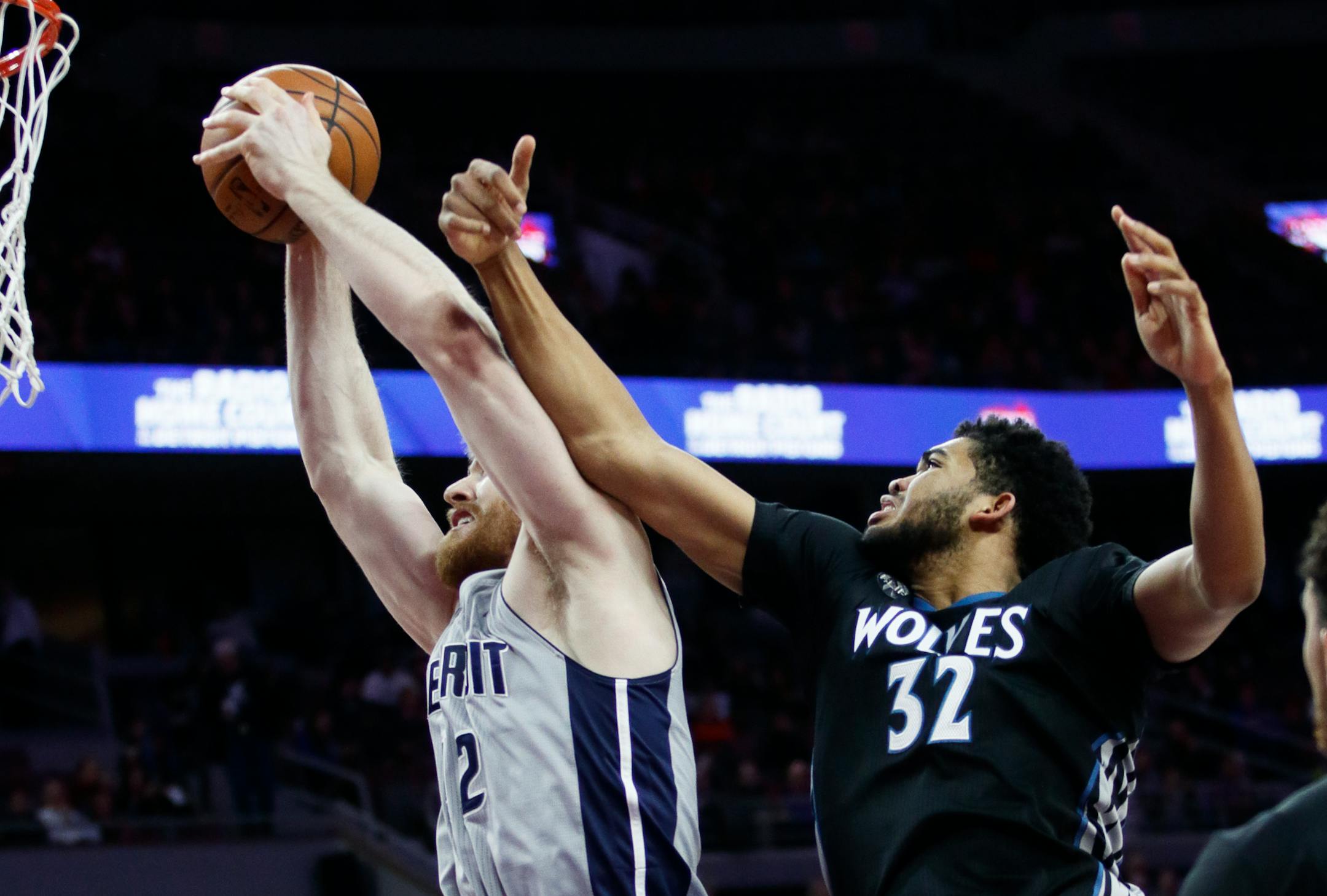 The Pistons' Aron Baynes grabbeds a rebound in in front of Timberwolves center Karl-Anthony Towns during the first half Thursday in Auburn Hills, Mich.