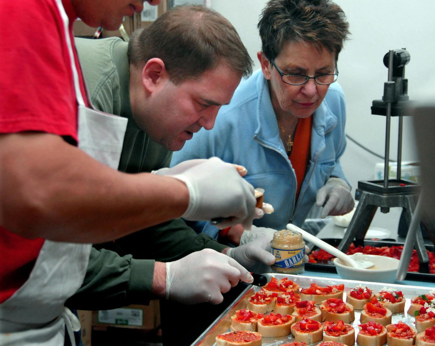 Totino's cook Johnny Soto, owner Steve Elwell and his mom, Joanne Elwell prepared bruschetta appetizers on Wednesday at Totino's Italian Kitchen, a Northeast institution.