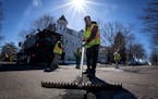 Workers with the city of St. Paul patch potholes along 6th Street on April 5.
