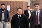 St. Paul City Council Member Dai Thao, left, walked with his attorney Joe Dixon, right, from the Ramsey County Law Enforcement Center following his he