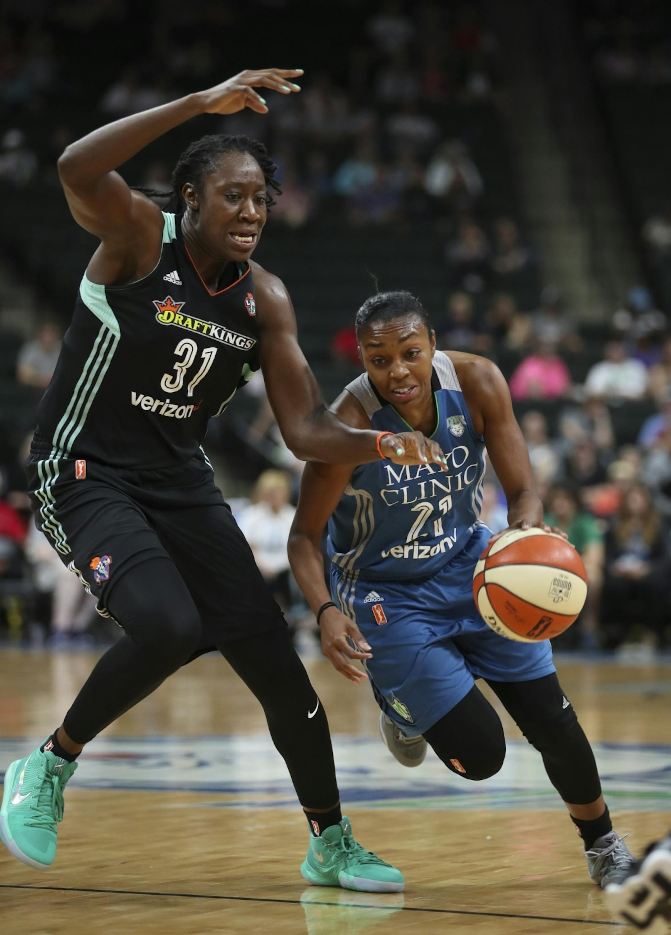 Minnesota Lynx guard Renee Montgomery (21) drove past New York Liberty center Tina Charles (31) in the first quarter.