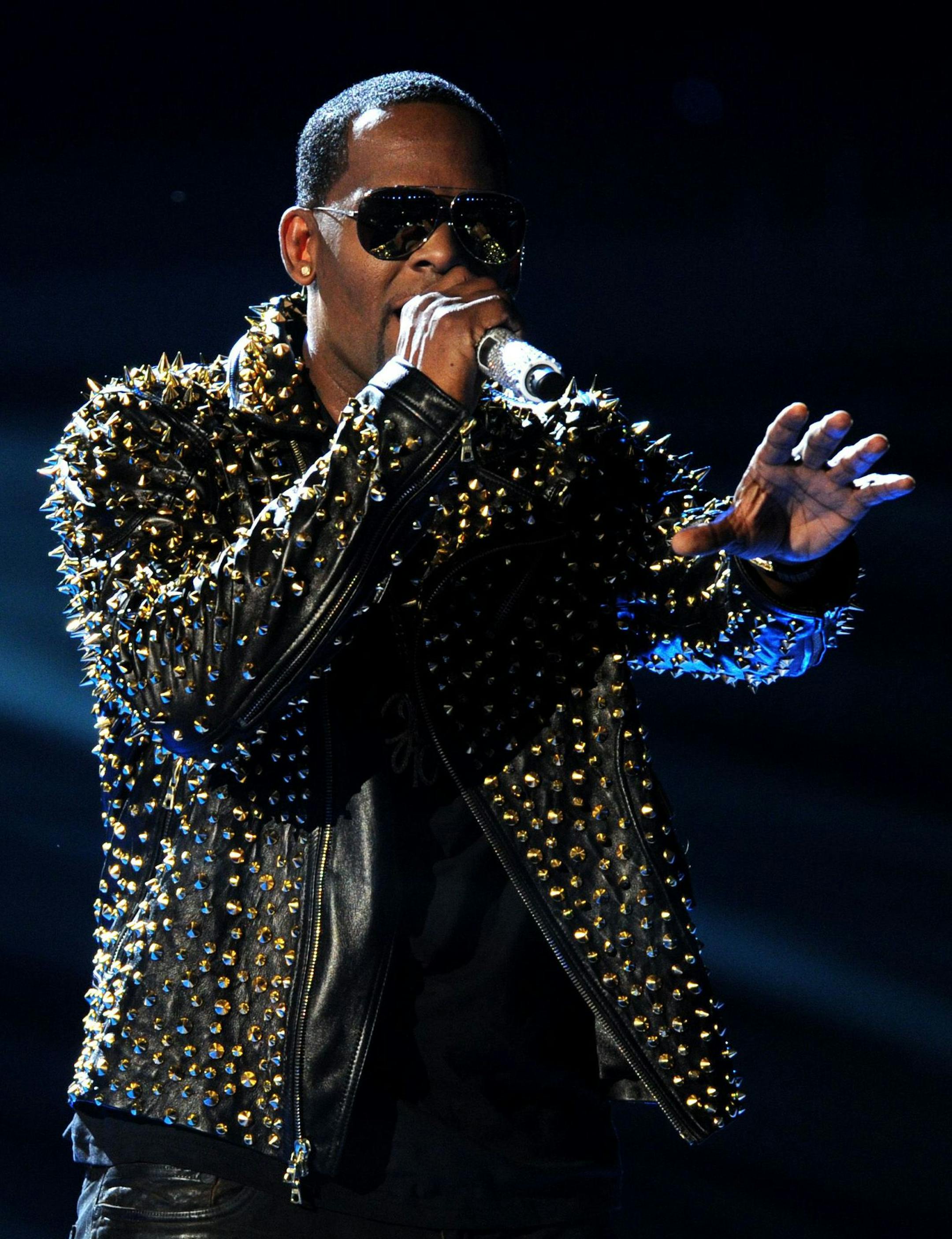 FILE - In this June 30, 2013 file photo, R. Kelly performs onstage at the BET Awards at the Nokia Theatre in Los Angeles. The owners of 5001 Flavors knew when they started the company 23 years ago they wanted to sell custom-made clothes to rap and R&B musicians. They sought out artists and record company executives at parties and music industry events. They looked in particular for up-and-coming artists. Now musicians like R. Kelly and Kid Rock are among their fans. (Photo by Frank Micelotta/Inv