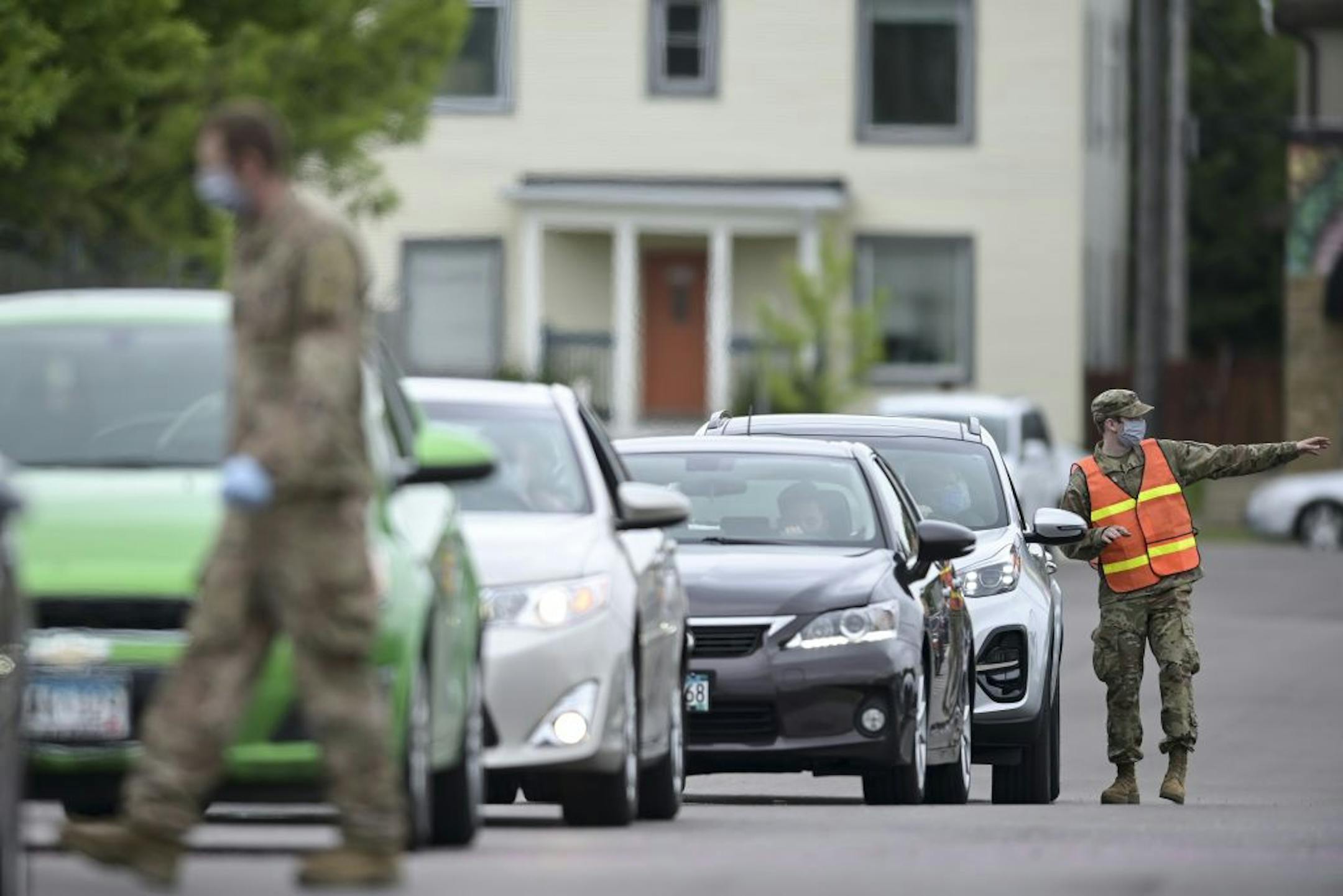 A National Guardsman talked to motorists in line to be tested for COVID-19 Saturday behind the Minneapolis Armory.