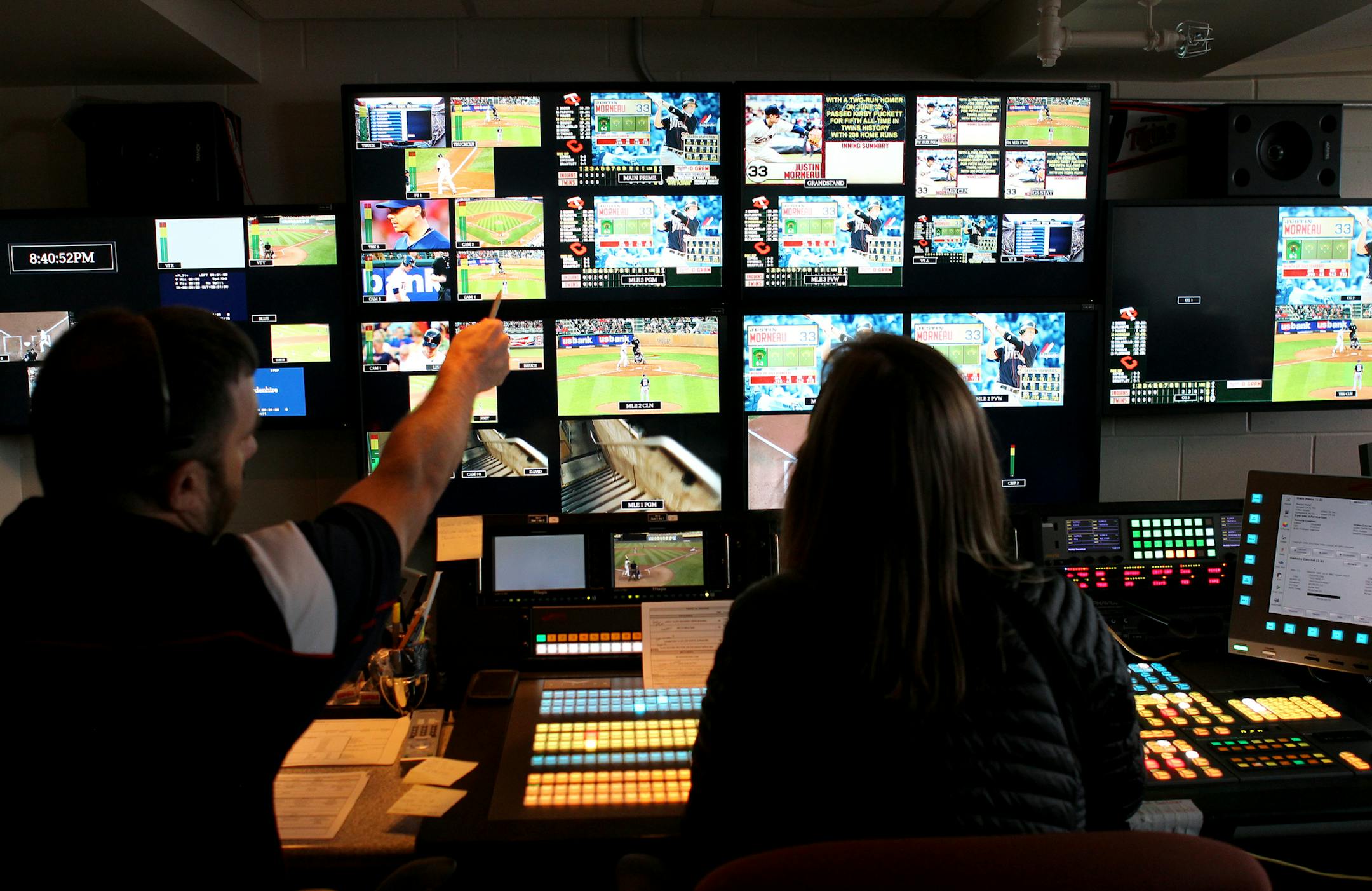 Jesse Marquette and Kari Ahlstrand control the operations of the scoreboard during the Cleveland Indians vs. Twins baseball game at Target Field in Minneapolis, Minn., on Friday, July 19, 2013. ] (ANNA REED/STAR TRIBUNE) anna.reed@startribune.com (cq)