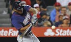 Minnesota Twins' Byron Buxton hits a solo home run as Los Angeles Angels catcher Carlos Perez watches during the sixth inning of a baseball game Monda