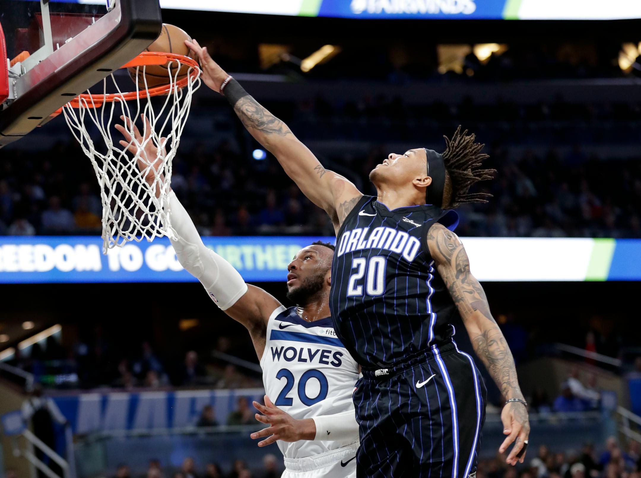 Orlando Magic guard Markelle Fultz, right, blocks a shot by Minnesota Timberwolves guard Josh Okogie