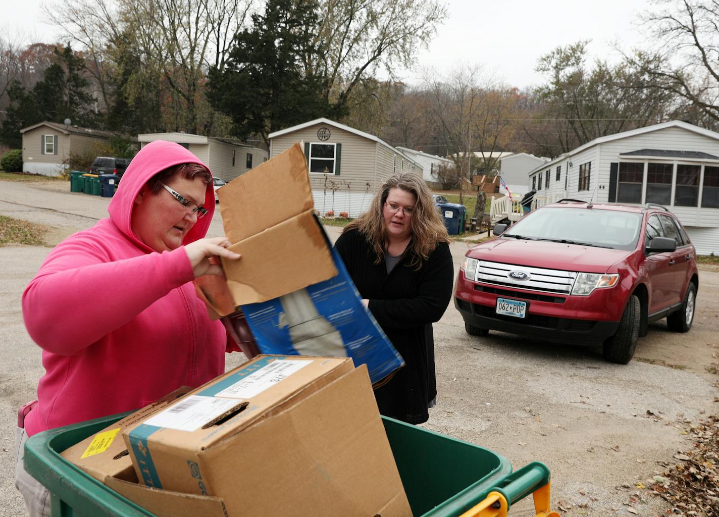 Krista Paulsen, left, and Hilari Erickson threw away boxes from a building that was formally the office for Zumbro Ridge Estates.