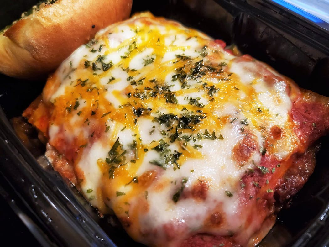 A slice of lasagna from Fast Eddie’s easily feeds two.