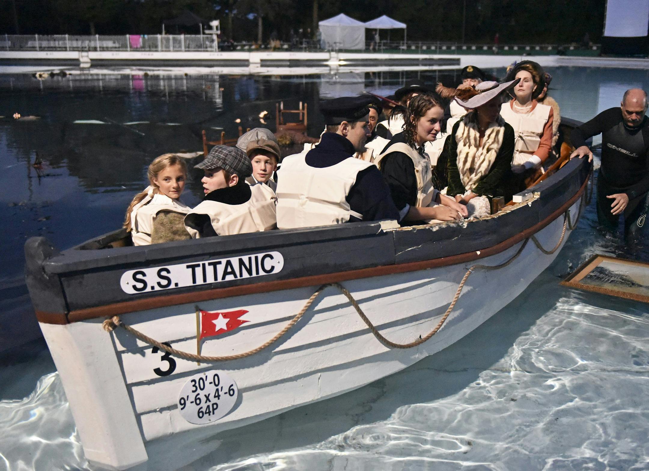Cast members of "Unsinkable," an independent movie about the sinking of the Titanic, look toward the "shore" upon the completion of the first day of shooting, just before 6 a.m. on Tuesday, Aug. 1, 2017 at the Settler's Cabin Wave Pool, in Pittsburgh. “Unsinkable,” an independent film project that follows the story of what happened to survivors of the 1912 Titanic disaster, is shooting closed-set scenes for the next three nights at Settler’s Cabin wave pool Tuesday in the So