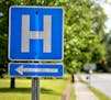 In this April 25, 2014 photo, a sign points the way to Flint River Hospital which closed its emergency room last year, in Montezuma, Ga. Residents mus