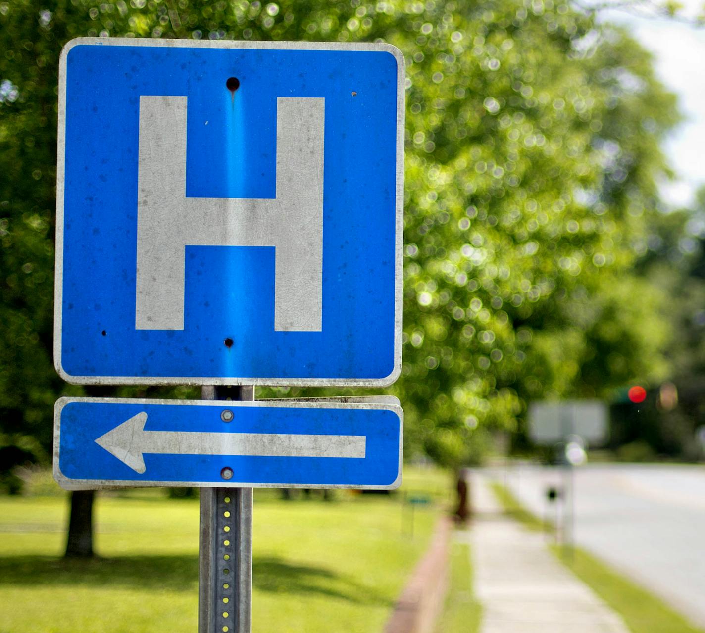 In this April 25, 2014 photo, a sign points the way to Flint River Hospital which closed its emergency room last year, in Montezuma, Ga. Residents must now drive 20 or 30 miles on slow country roads to the nearest hospital. Alarmed by hospital closures, health officials in Georgia are changing rules to let stressed rural hospitals become expanded emergency rooms that can also handle routine childbirths or outpatient surgery. (AP Photo/David Goldman) ORG XMIT: GADG213