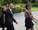 FILE - In this Aug. 30, 2014 file photo, President Barack Obama, accompanied by first lady Michelle Obama, waves as they follow their daughters Sasha,